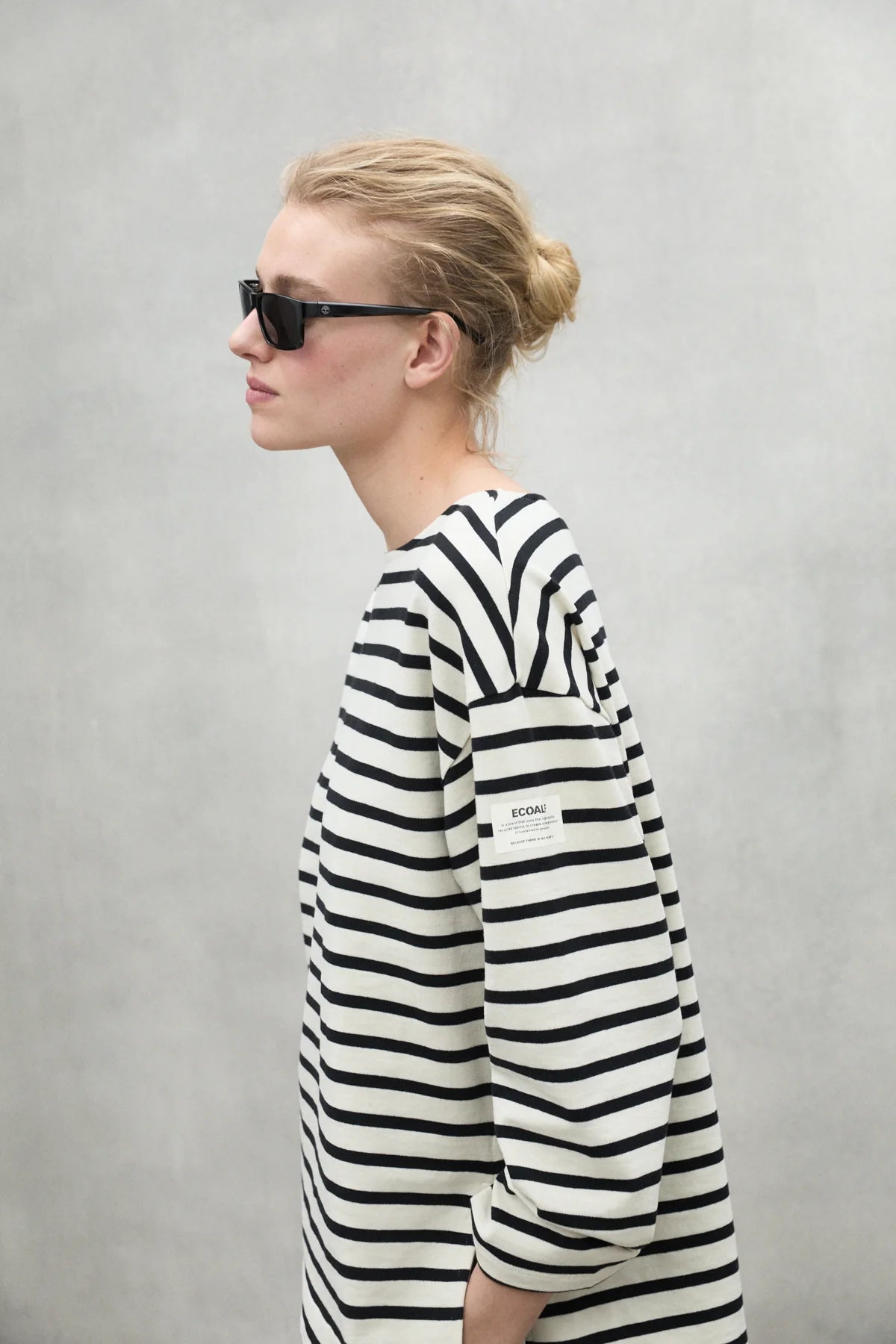Black and white horizontally striped long-sleeve shirt with a boat neck and a small brand label on the sleeve.