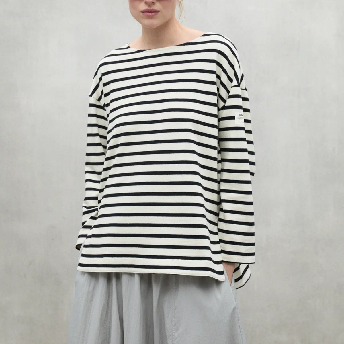 Black and white horizontally striped long-sleeve shirt with a boat neck.