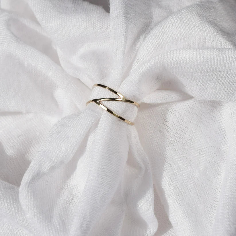 Gold double-band ring with an angular, intersecting design.