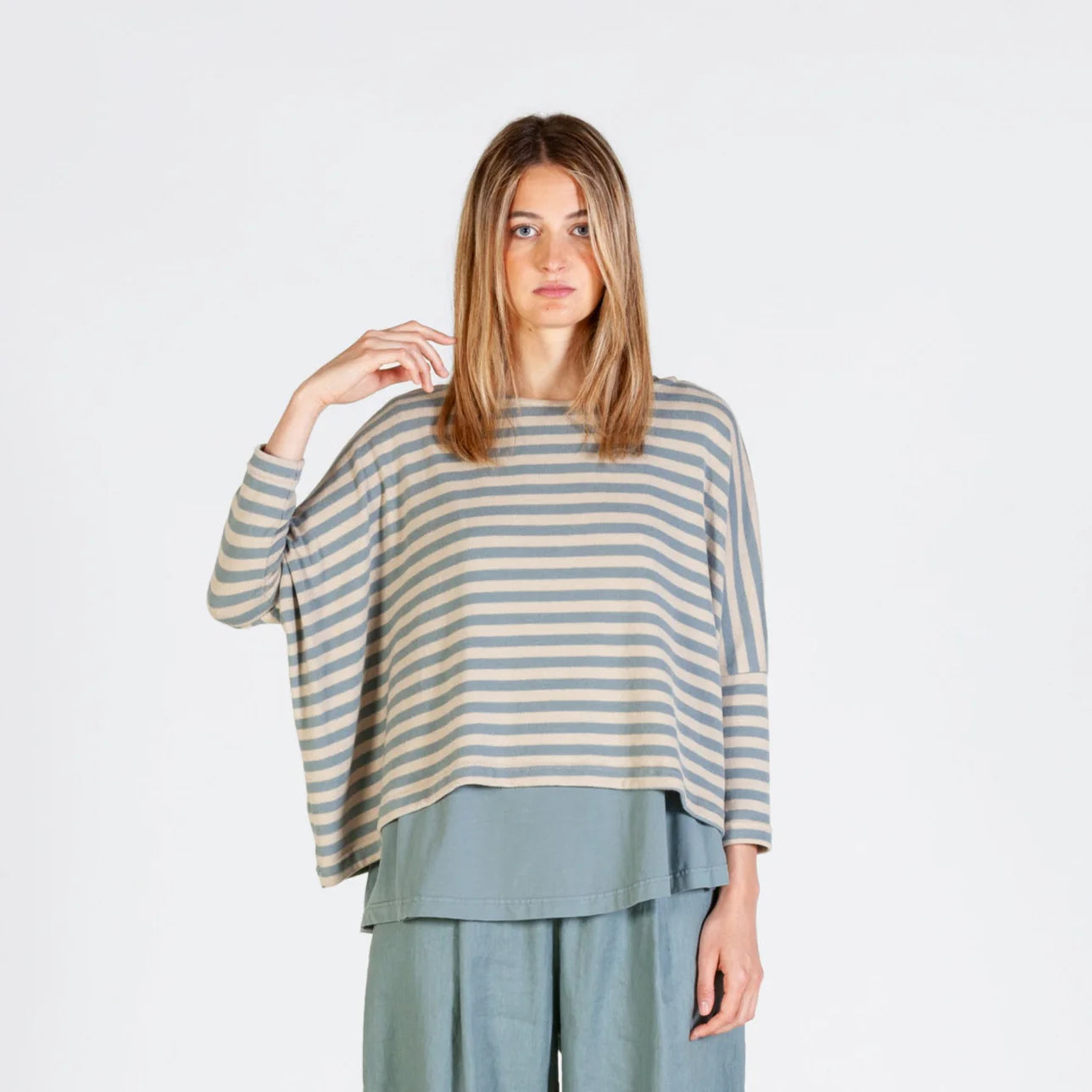 Horizontal striped, three-quarter sleeve top with a layered, longer back hem, paired with matching loose-fitting pants.