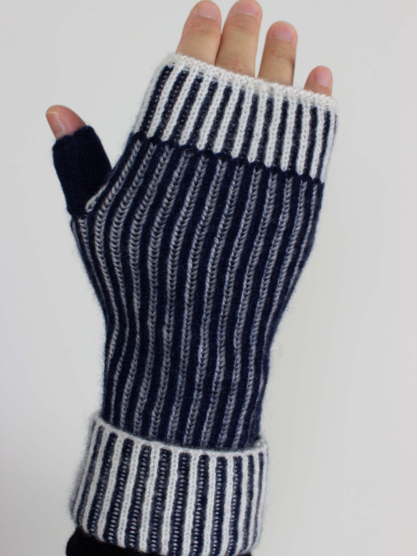 Black and white striped fingerless glove on a neutral background