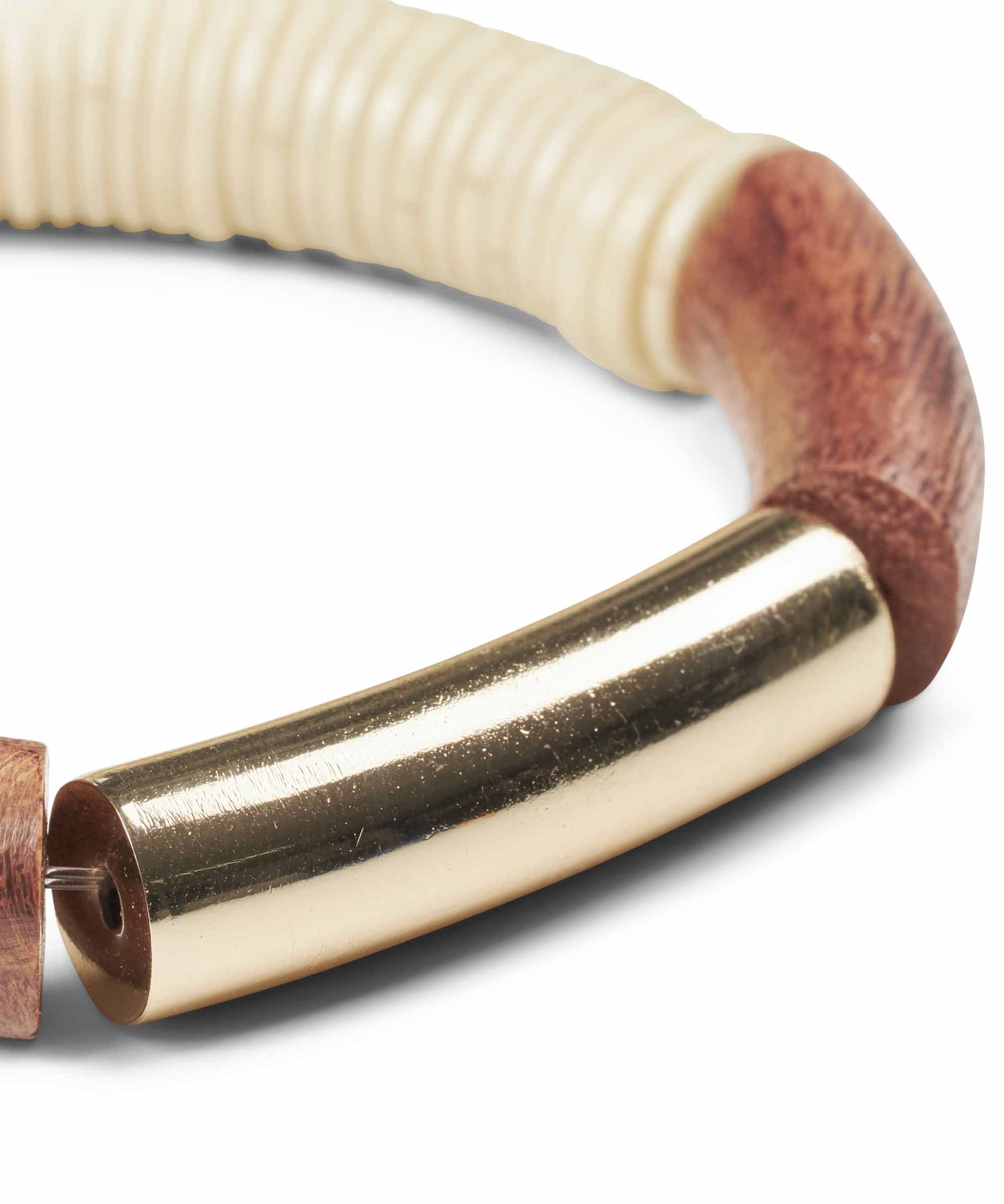 Close-up of a wooden and gold bracelet.