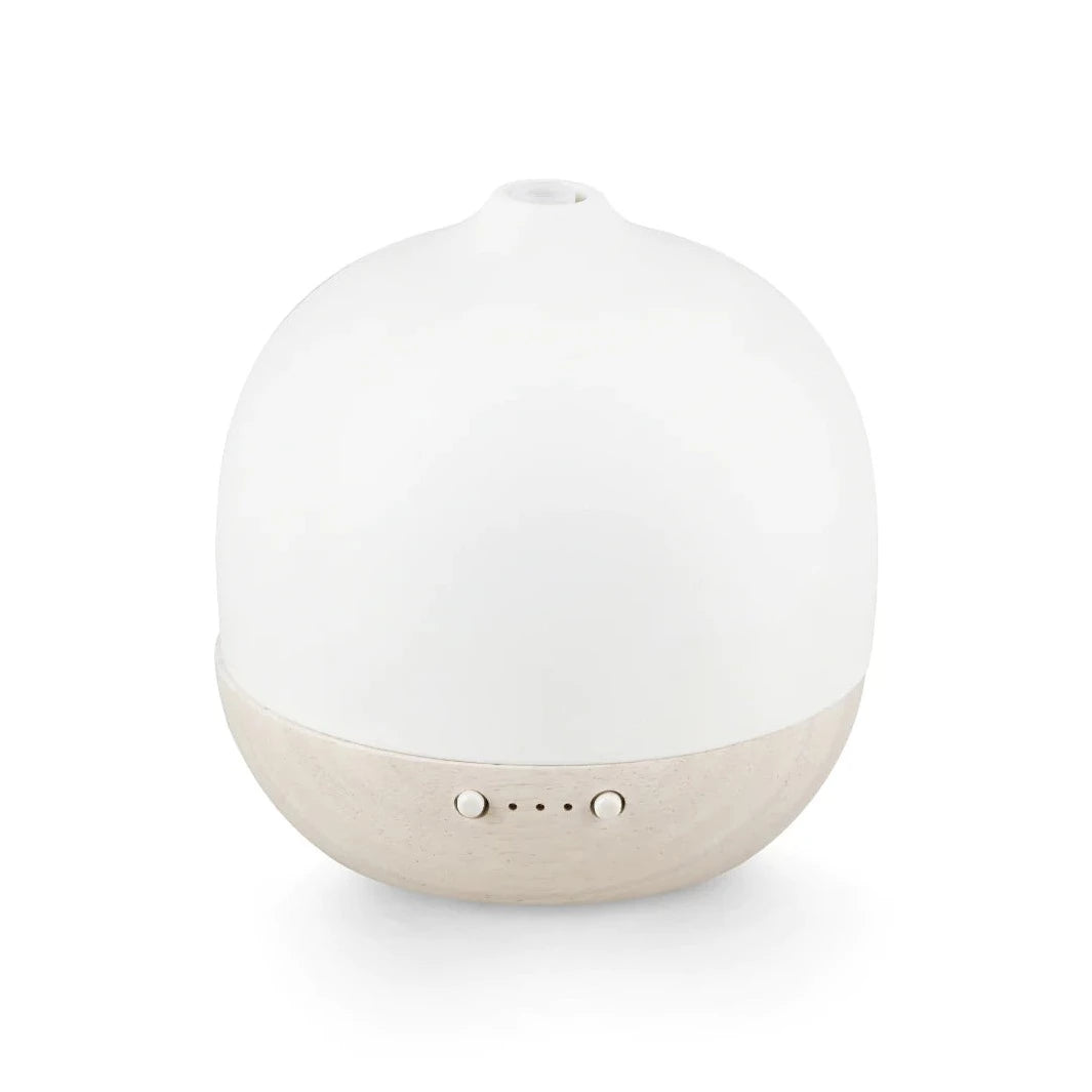 White ceramic essential oil diffuser with light beige wooden base and three control buttons.