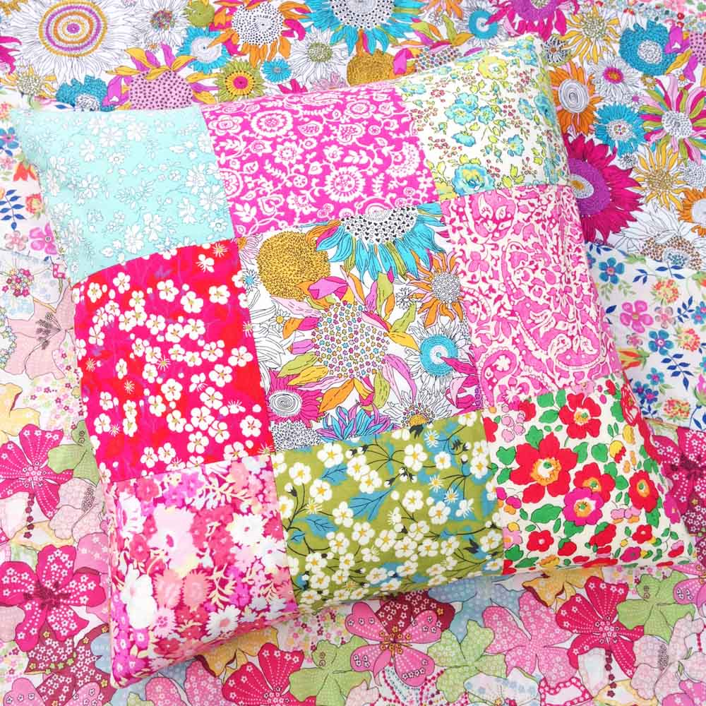 Patchwork cushion with a vibrant floral design.