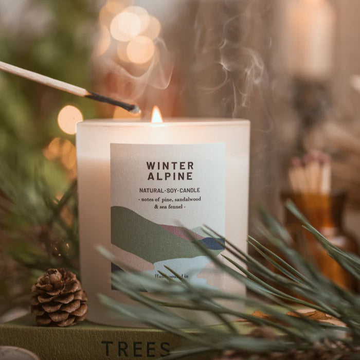 Winter Alpine natural soy candle, frosted glass jar with label featuring pine, sandalwood, and sea fennel notes.