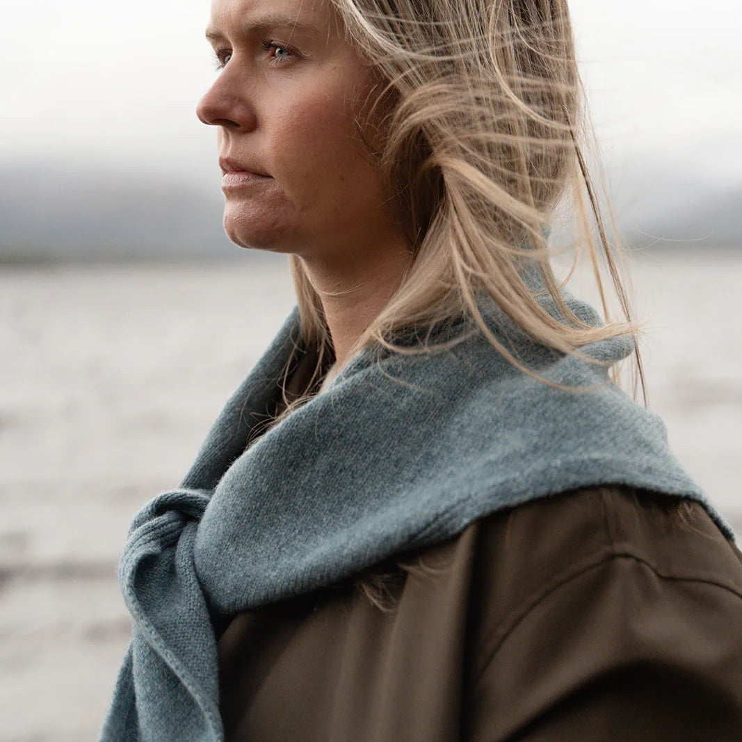 Woman wearing a blue scarf with a blurred background