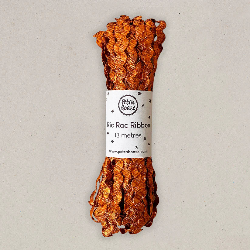 Orange ric rac ribbon with a label on a light gray background