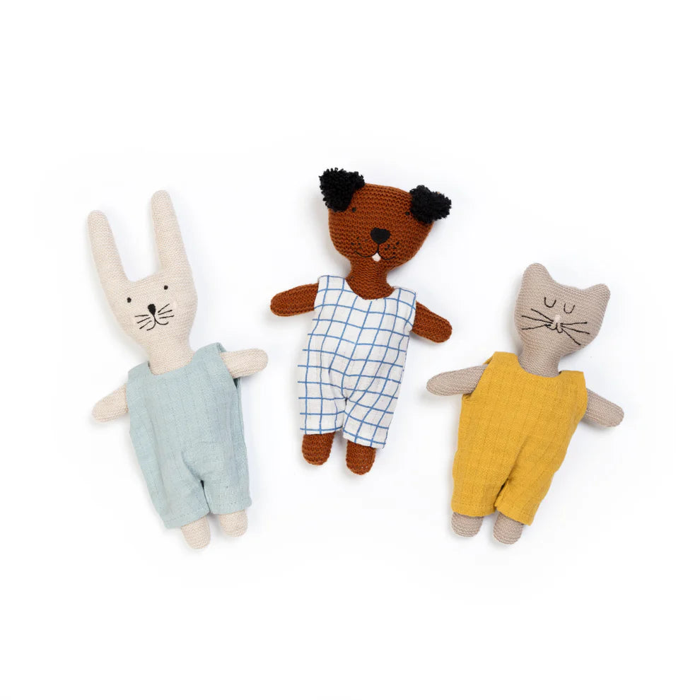 Three crocheted stuffed animals: a rabbit in teal overalls, a dog in blue and white checked overalls, and a cat in mustard