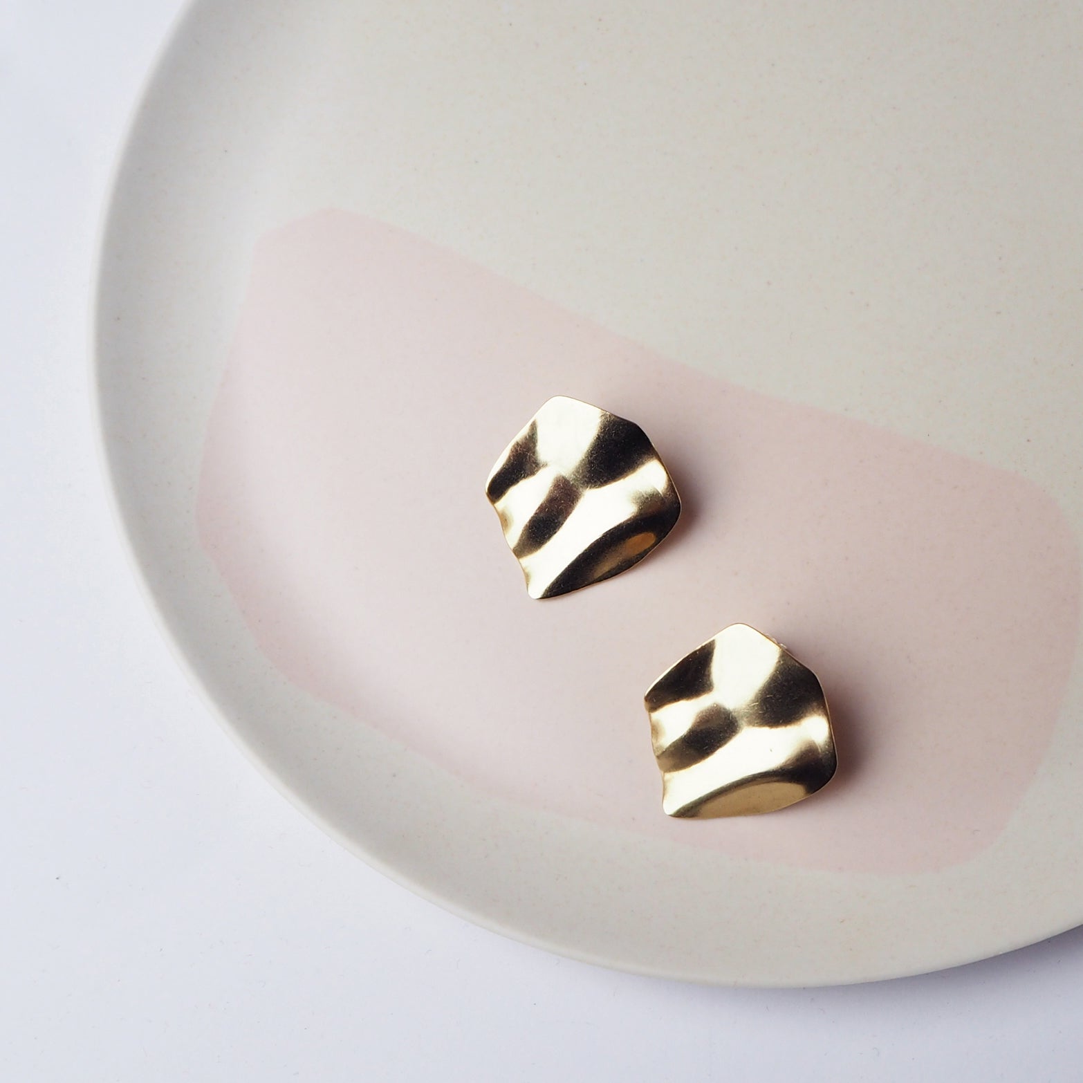 Pair of gold, textured, irregular-shaped earrings.