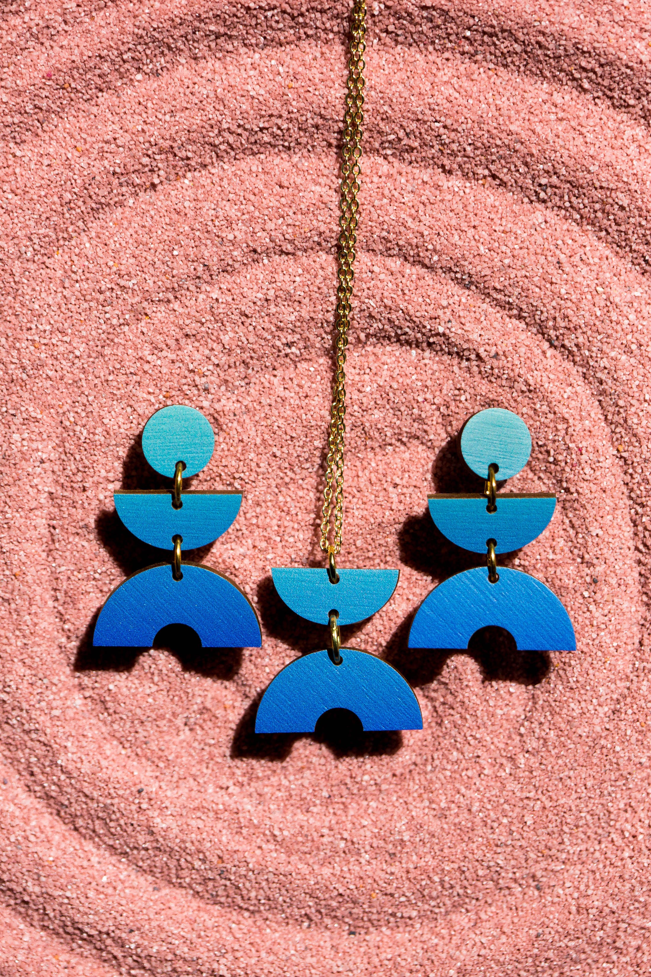 Blue ombre wood statement necklace and earrings.  Geometric semicircle and circle shapes. Gold chain.