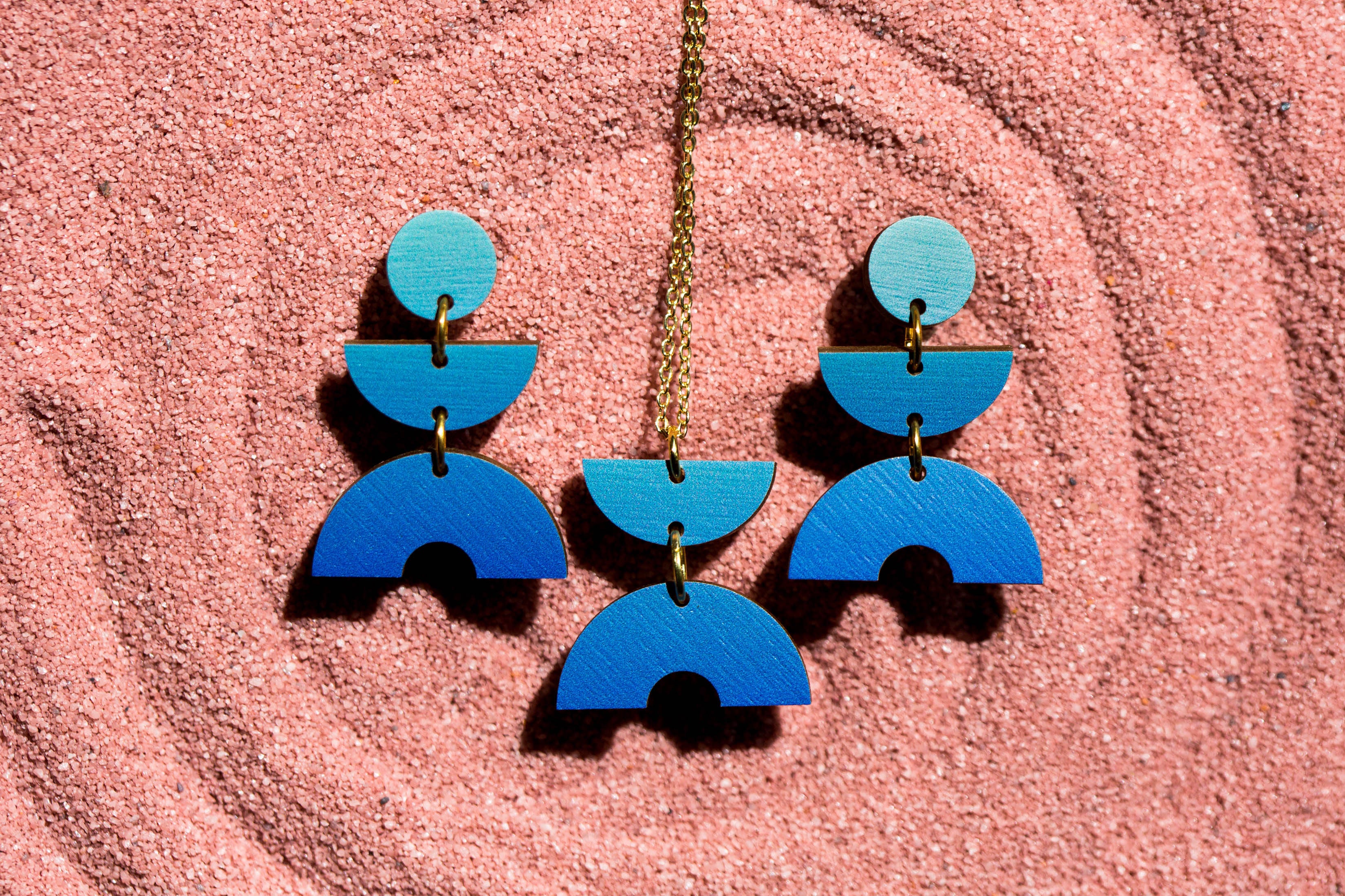 Blue ombre geometric earrings and a matching necklace.