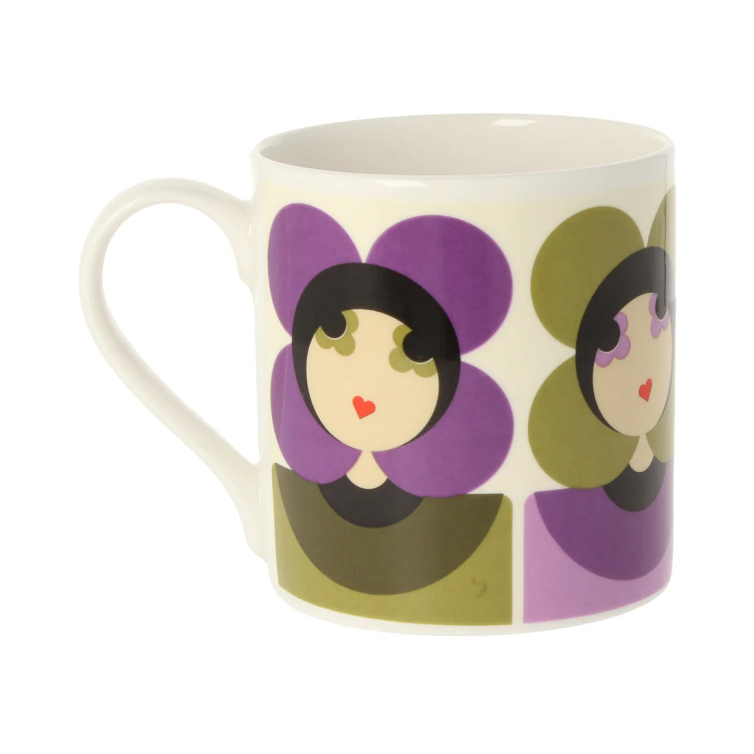 Mug with decorative design of stylized faces on a white background