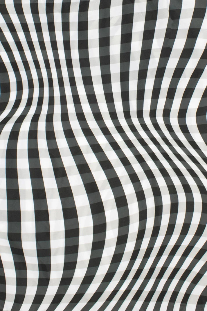Black and white striped fabric with a wavy, draped texture.