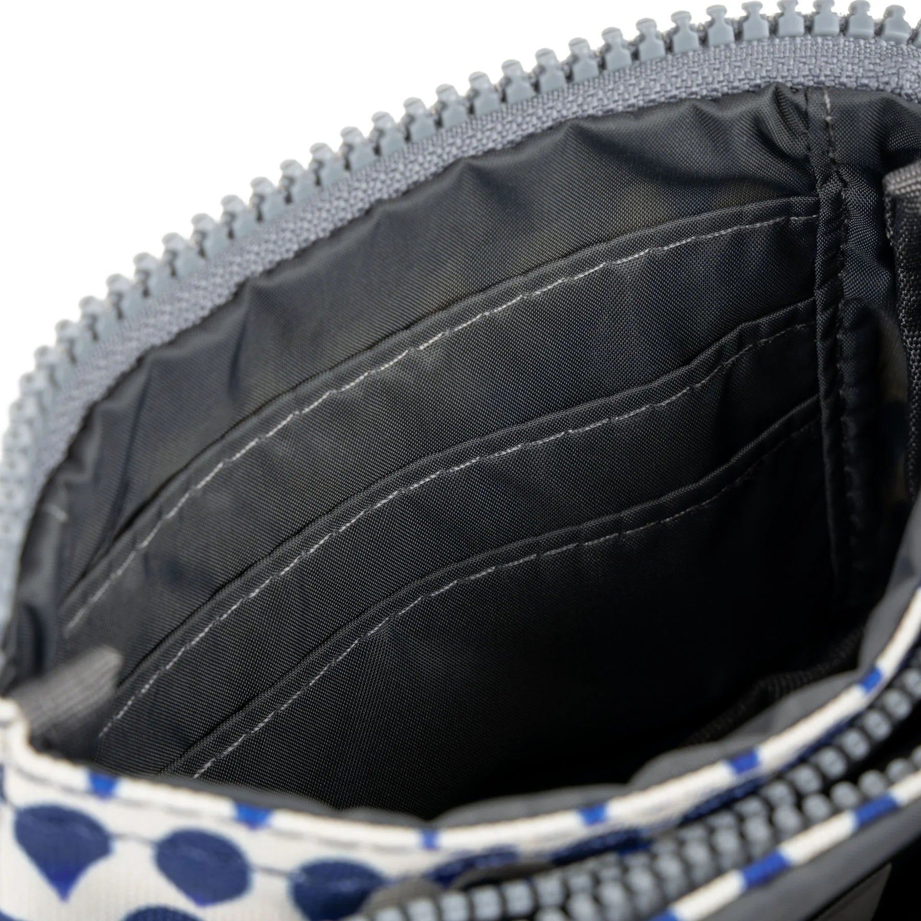 Interior view of a ROKA bag showing multiple compartments and a zipper.