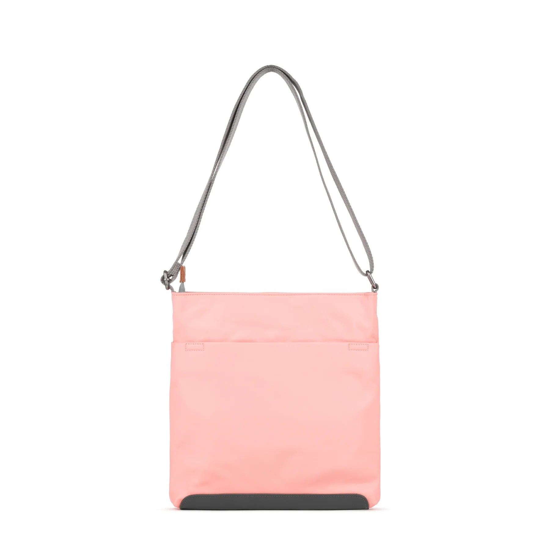 ROKA pink crossbody bag with a grey strap, featuring a sleek design and front pocket for easy access.