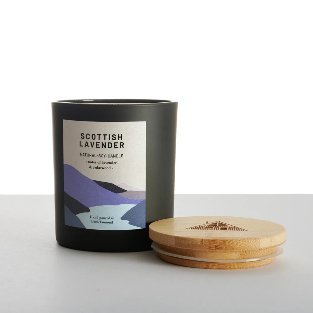 Black soy candle with a light-colored label reading "Scottish Lavender," featuring lavender and cedarwood notes.
