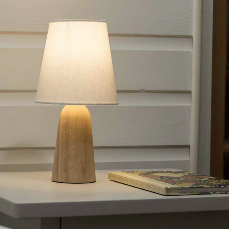 Wooden table lamp with off-white fabric shade.