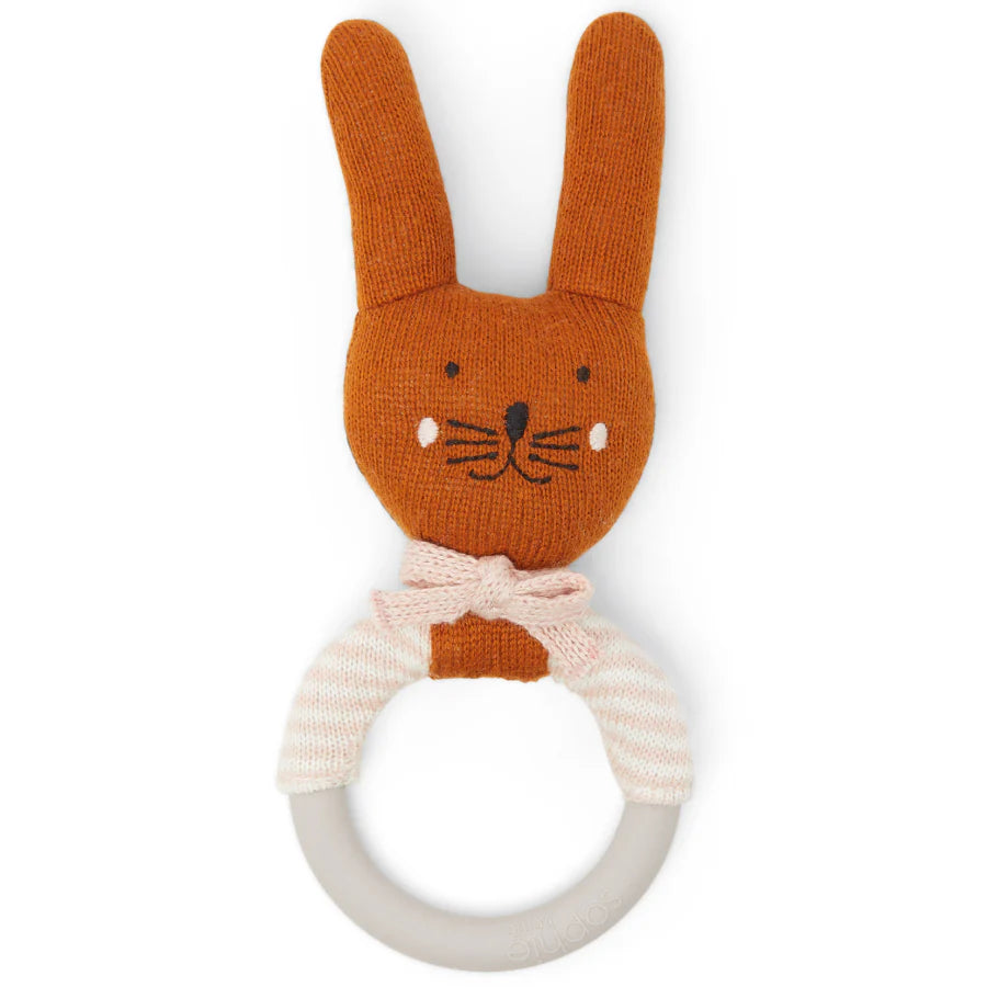 Knitted orange bunny rattle with a grey silicone ring and pink and white striped cuffs.