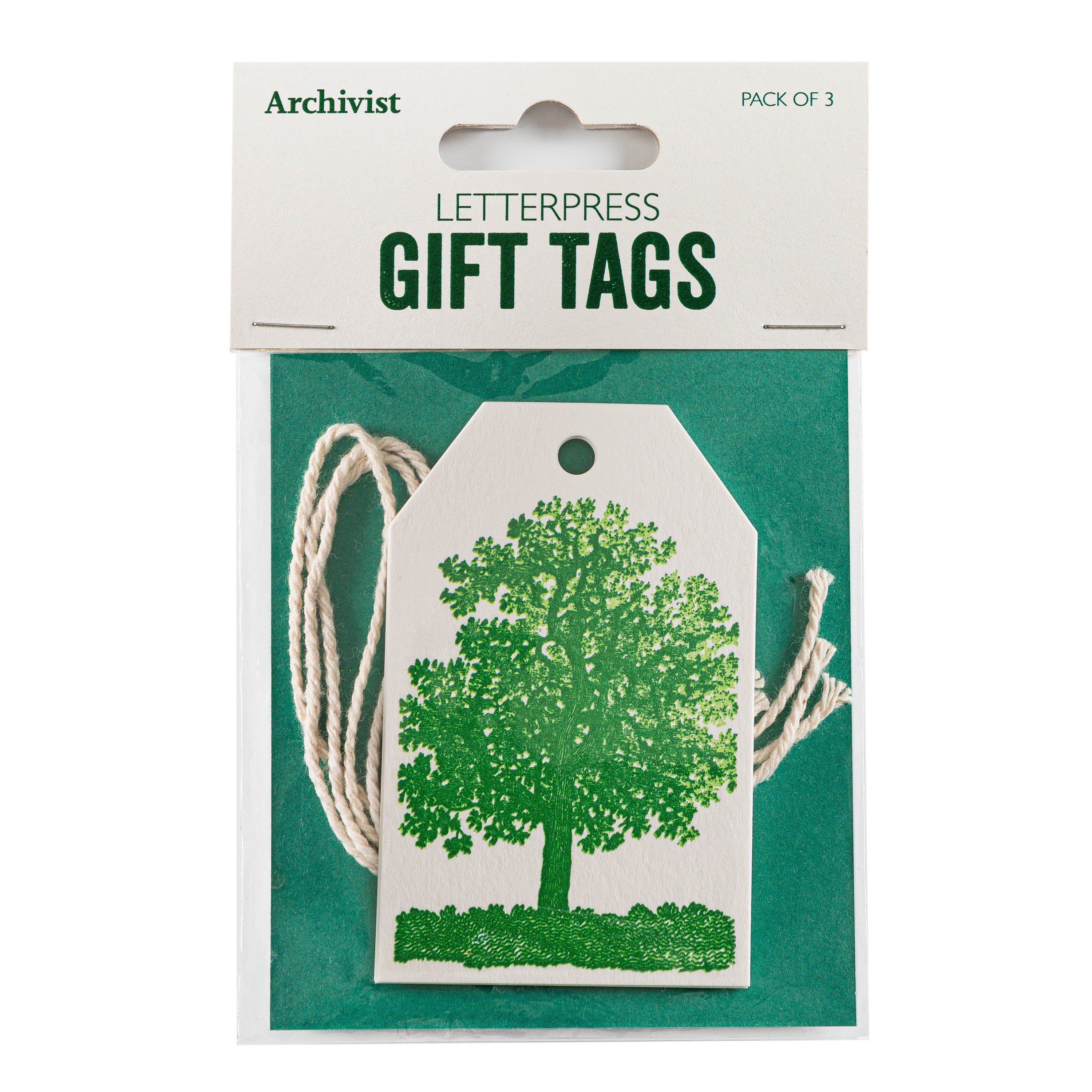 Pack of three letterpress gift tags featuring a green tree design. Off-white tags with cream-colored twine.