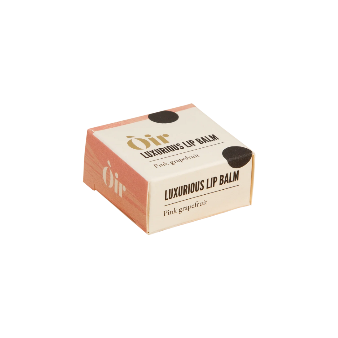Box of Oir luxurious lip balm with pink grapefruit flavor on a white background