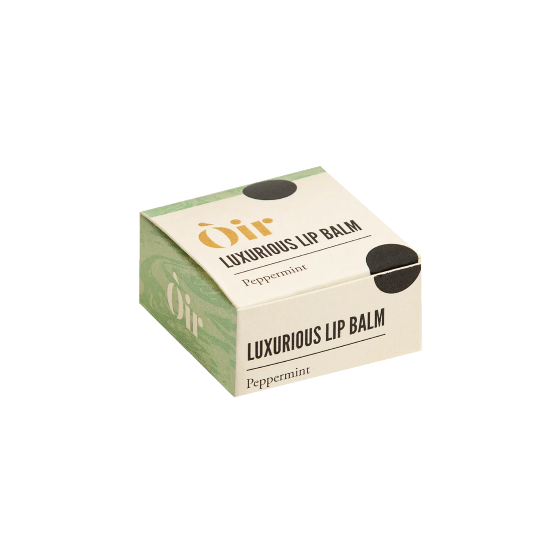 Box of Oir luxurious lip balm with peppermint flavor on a white background