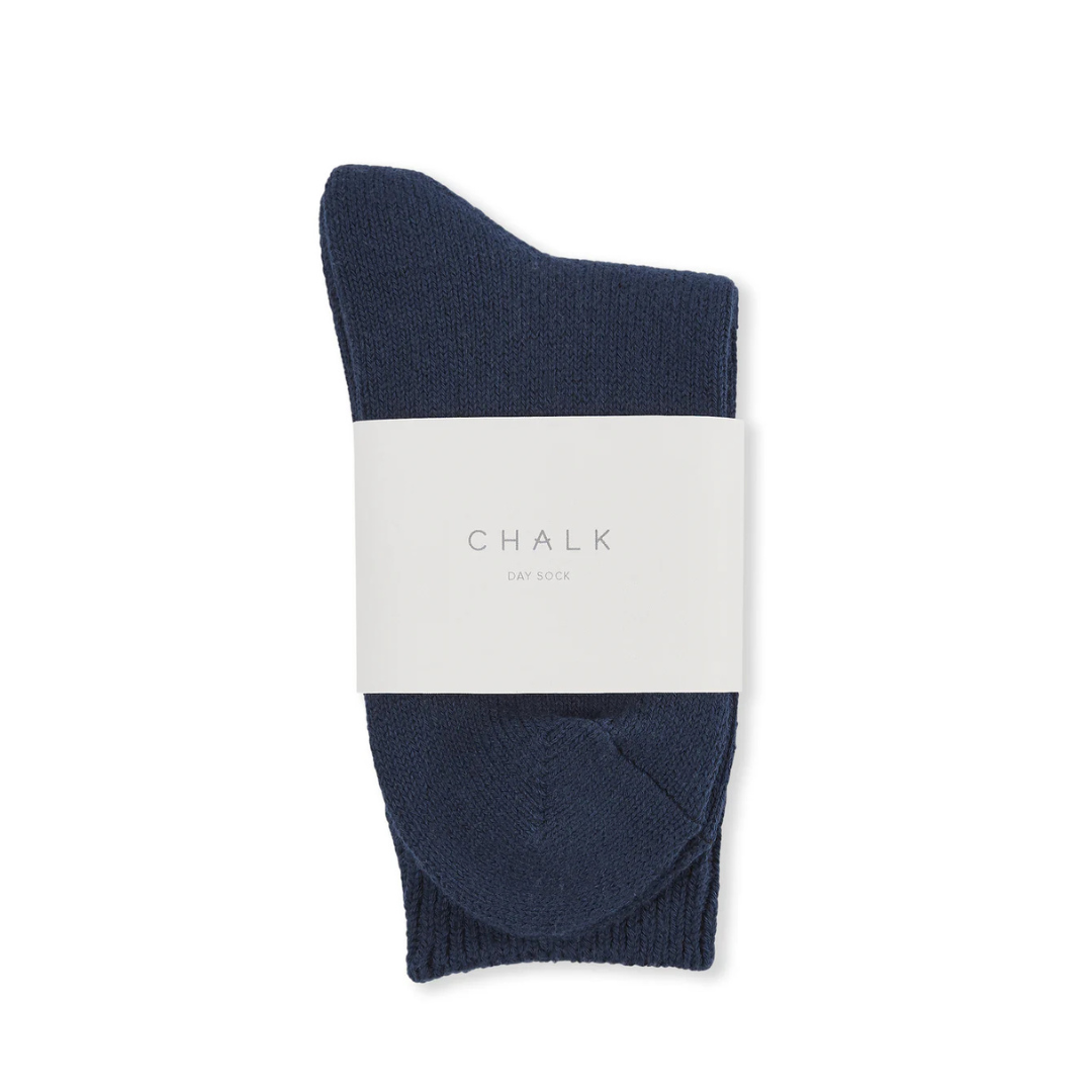 Navy sock with a white label on a white background