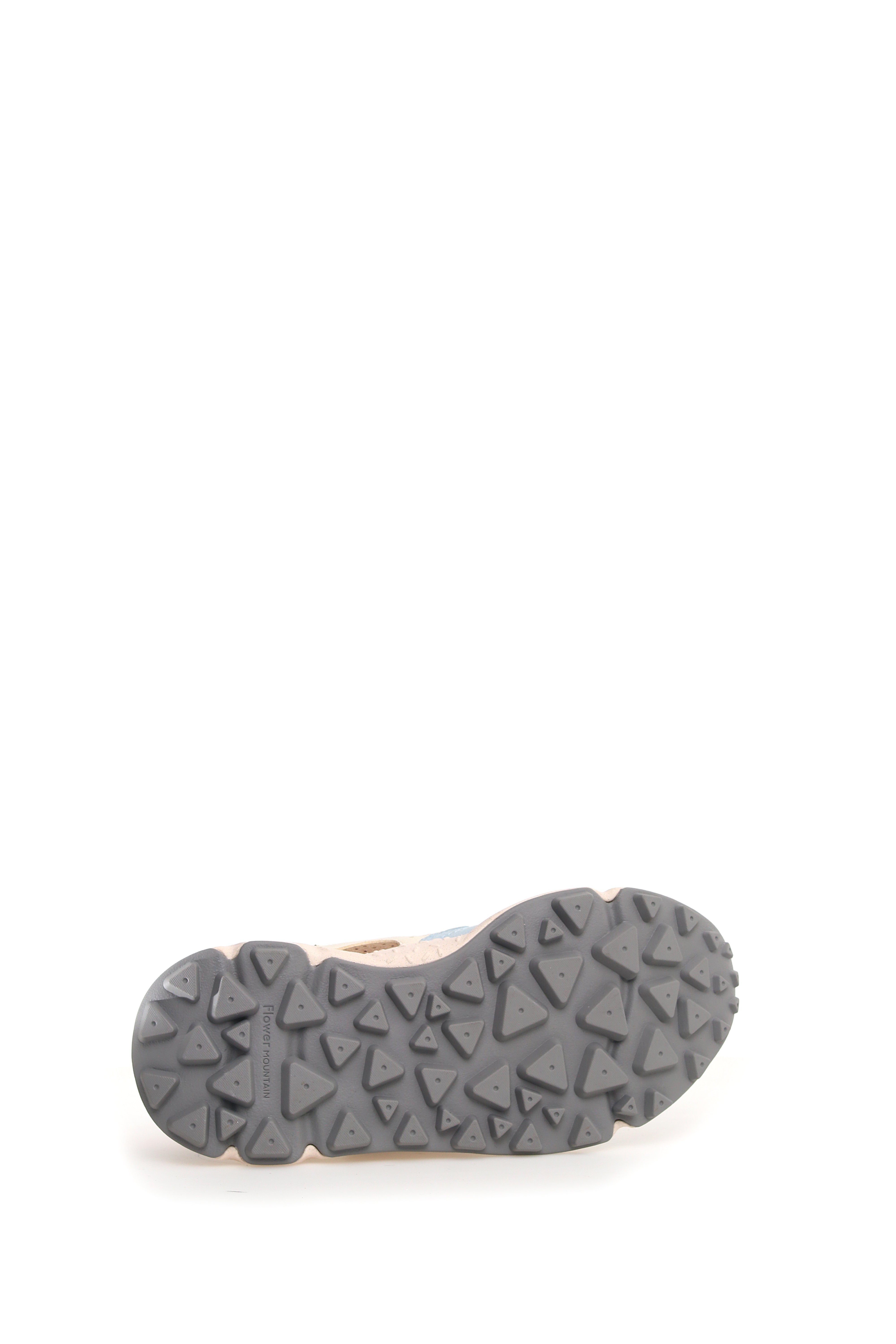 Close-up of a shoe's sole, featuring a gray, textured outsole with triangular patterns and small dots.