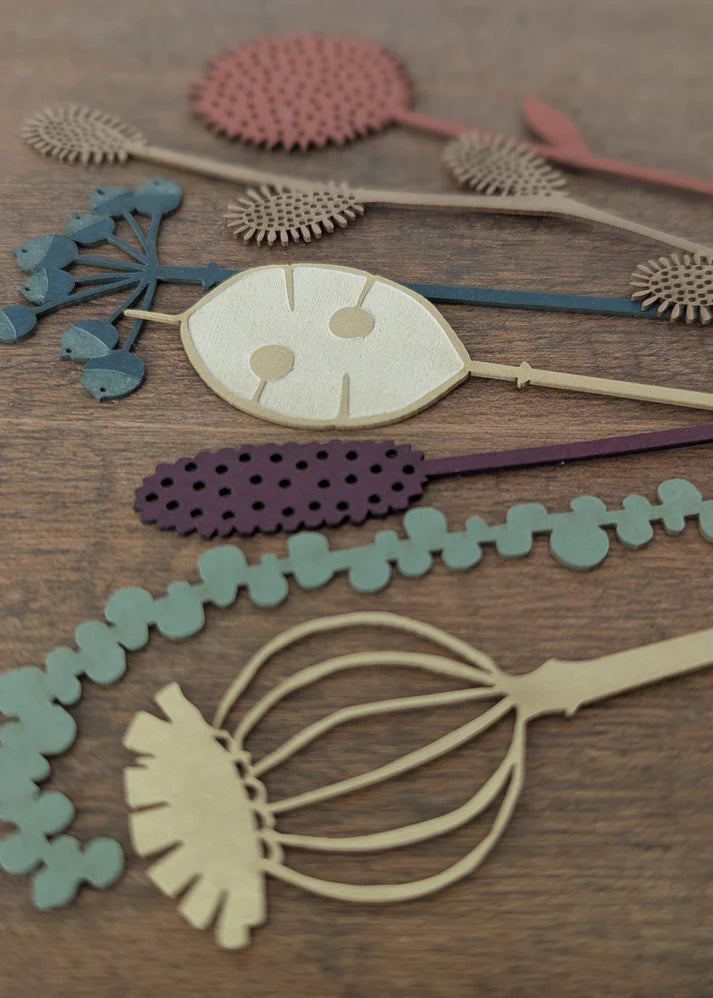 Decorative paper cutouts on a wooden surface