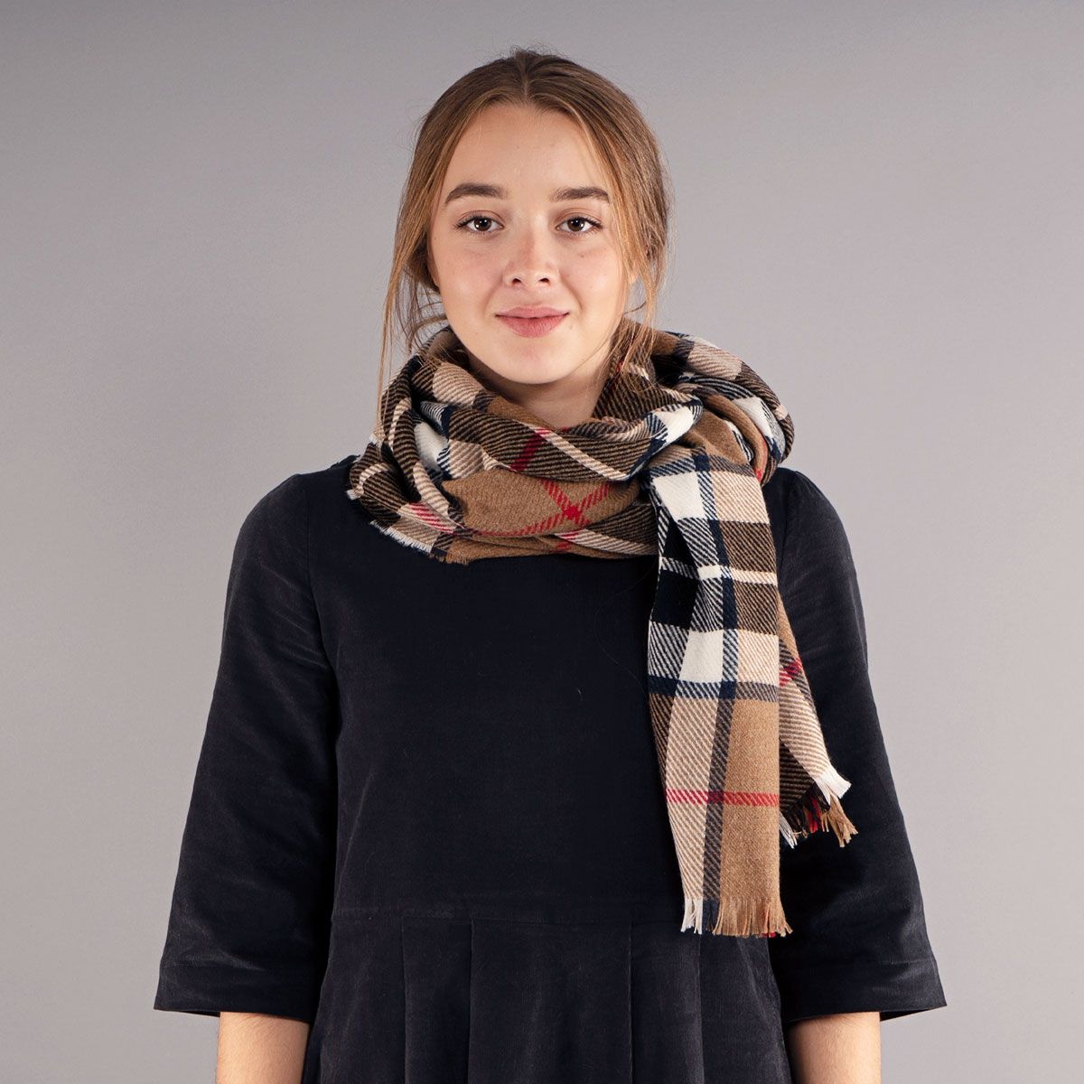 Brown, cream, and navy plaid scarf with frayed edges.