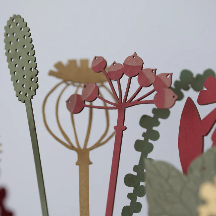 Close-up of stylized floral and plant designs on a white background