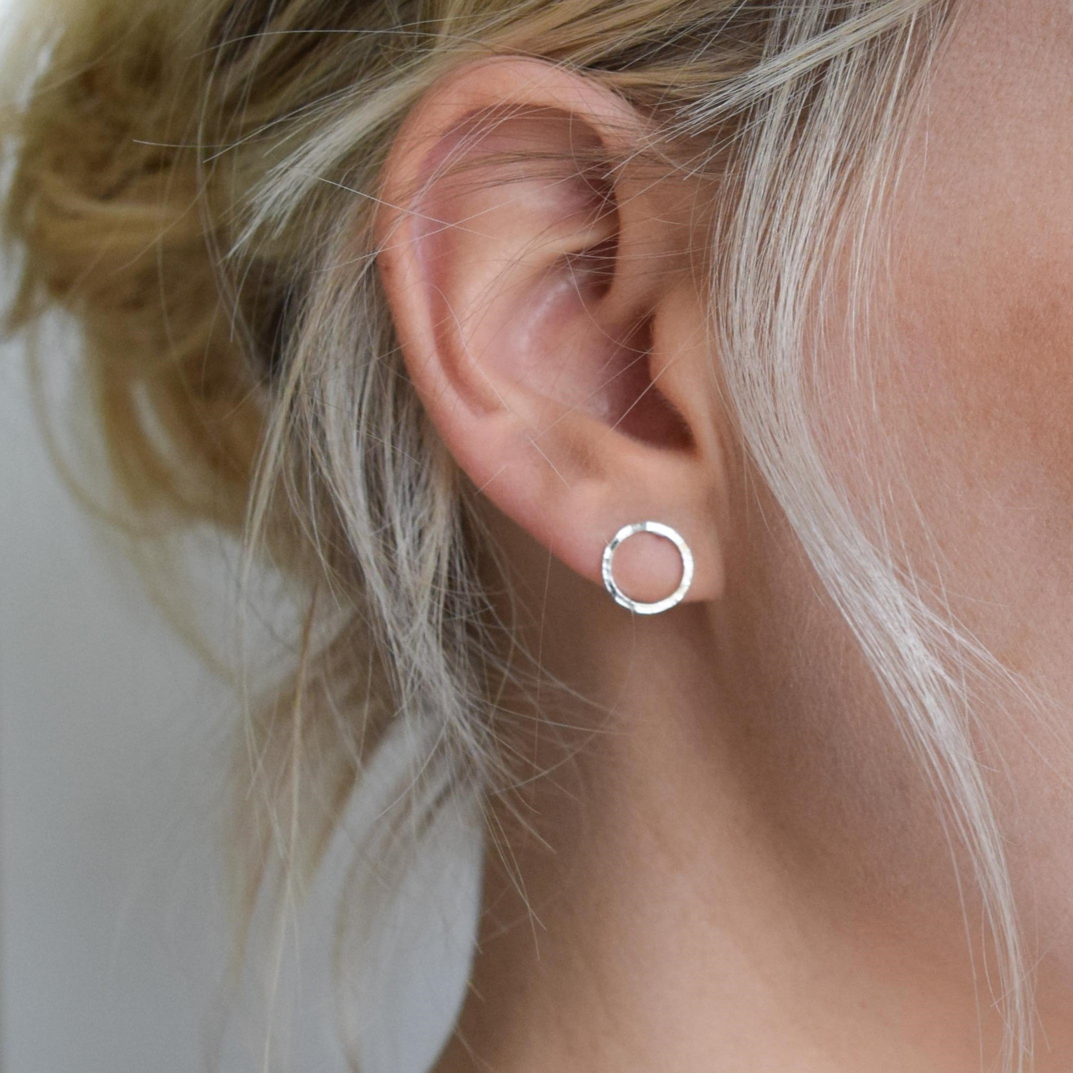 Silver hammered circle stud earrings.
