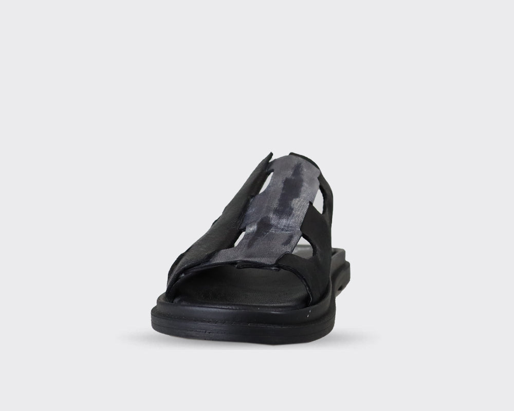 Black leather slide sandal with cut-out detailing and a grey-toned accent panel.  The sole is thick and black.