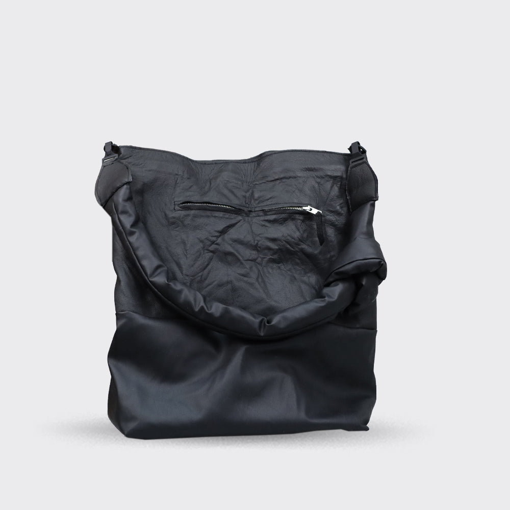 Large black leather tote bag with a gathered top and small zippered pocket.
