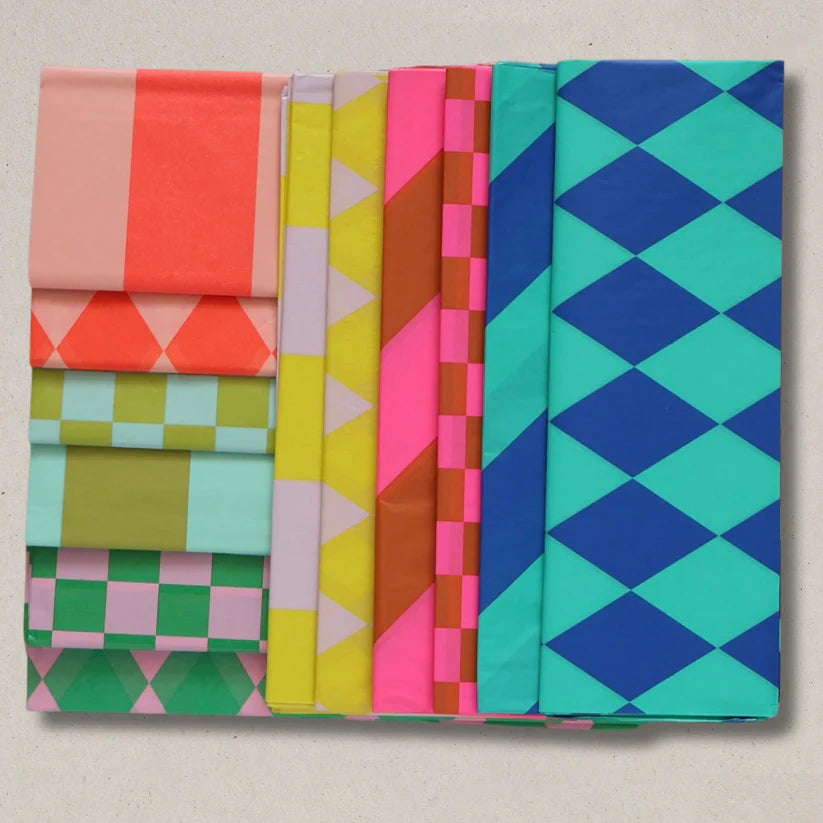Set of colorful fabric swatches with geometric patterns on a beige background