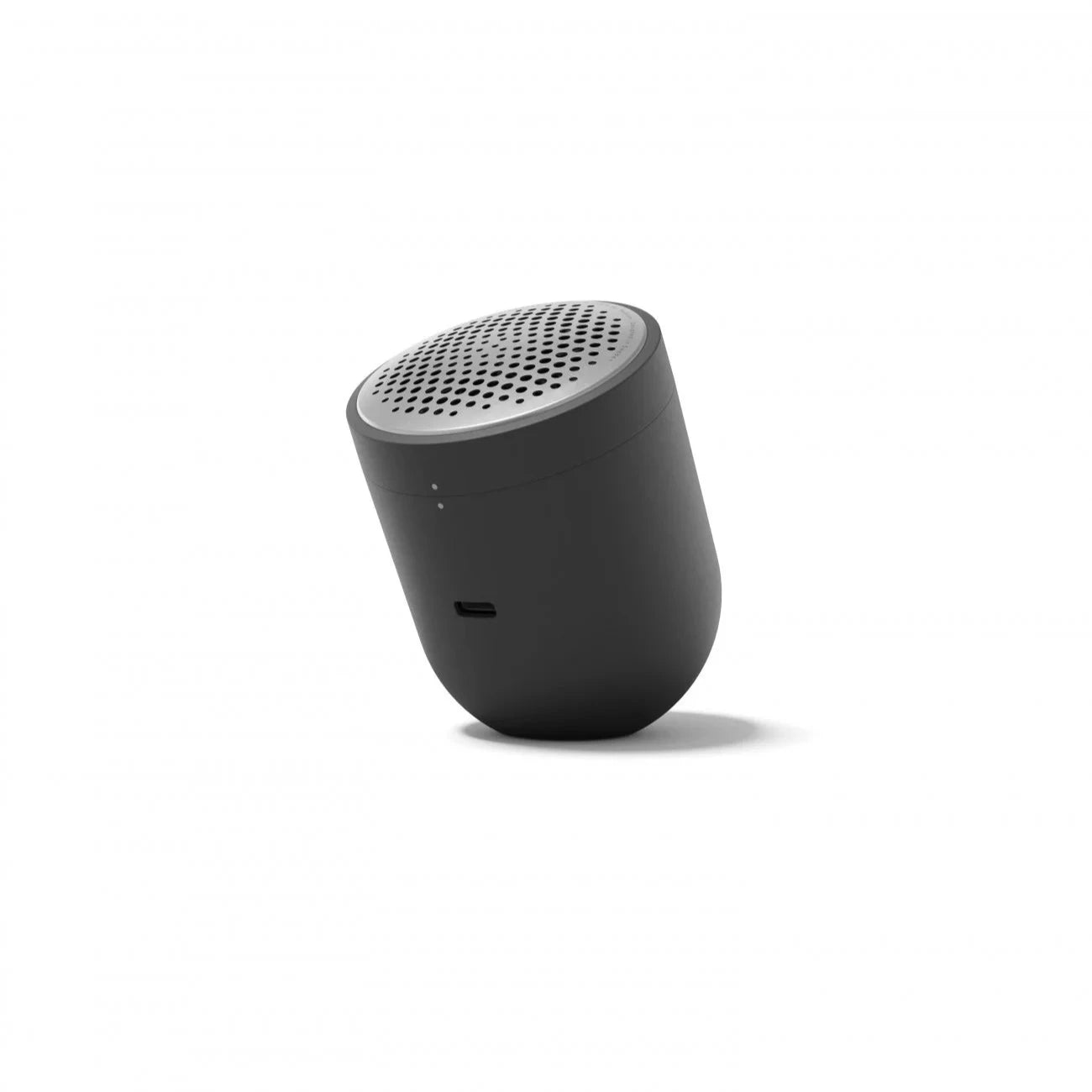 Compact dark gray portable Bluetooth speaker with a silver perforated top.