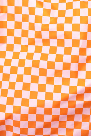 Orange and pink checkered fabric with a slight wrinkle.