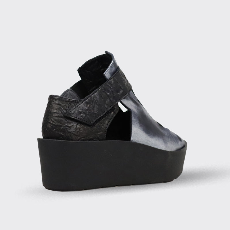 Black leather wedge sandal with textured strap and cutout detail.