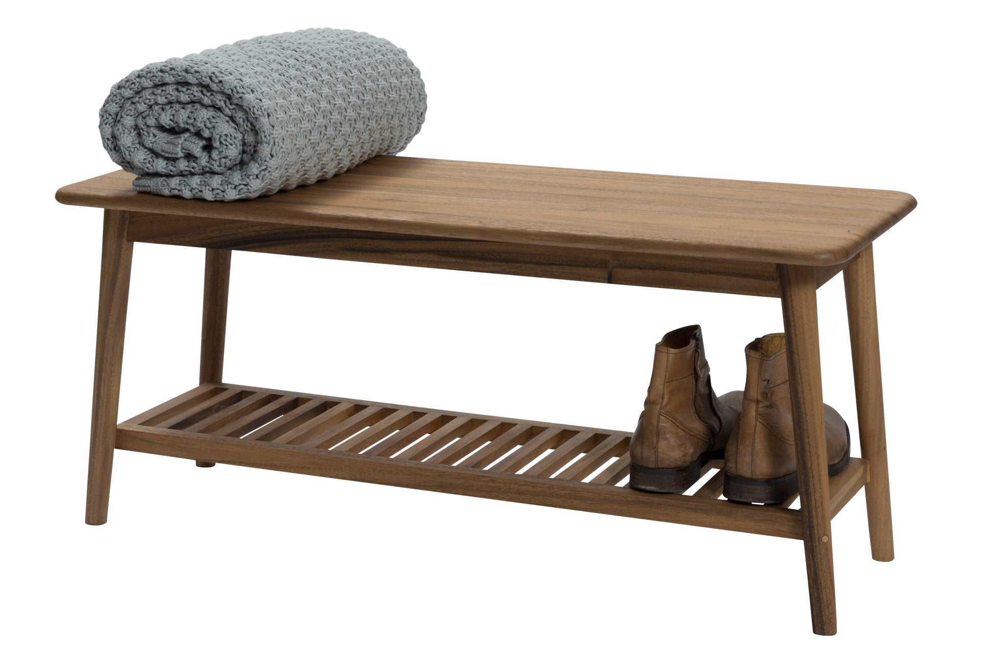 Wooden bench with a slatted lower shelf, holding a pair of brown boots, and a rolled gray blanket on top.