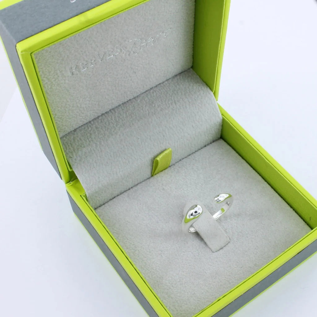 Silver ring with smooth, rounded ends, displayed in a lime green and grey jewelry box.