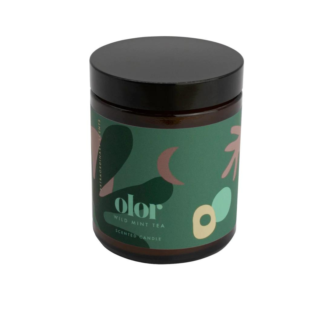 Amber glass jar candle with black lid.