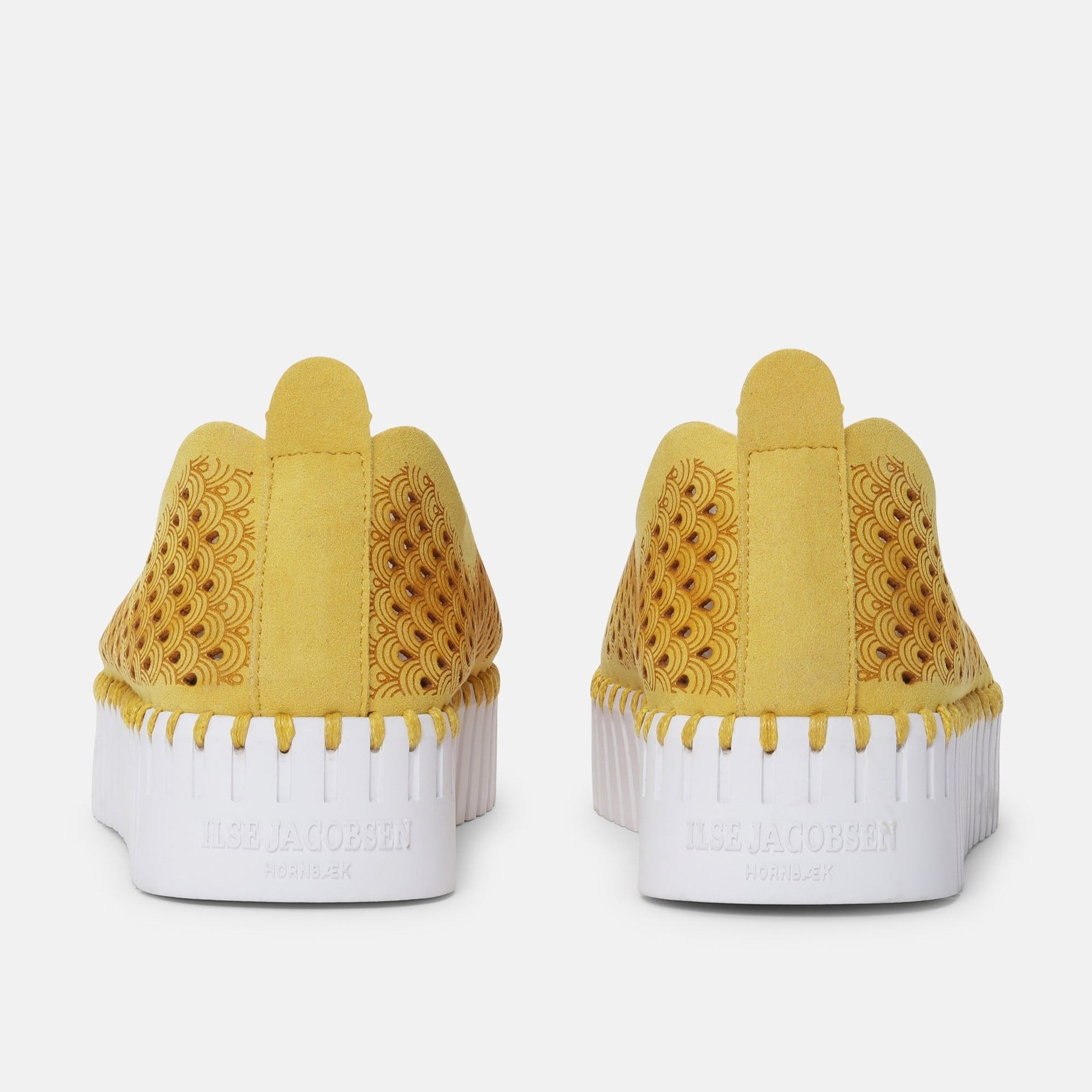Ilse Jacobsen Hornbæk yellow suede slip-on shoes with intricate laser-cut pattern and white platform sole.