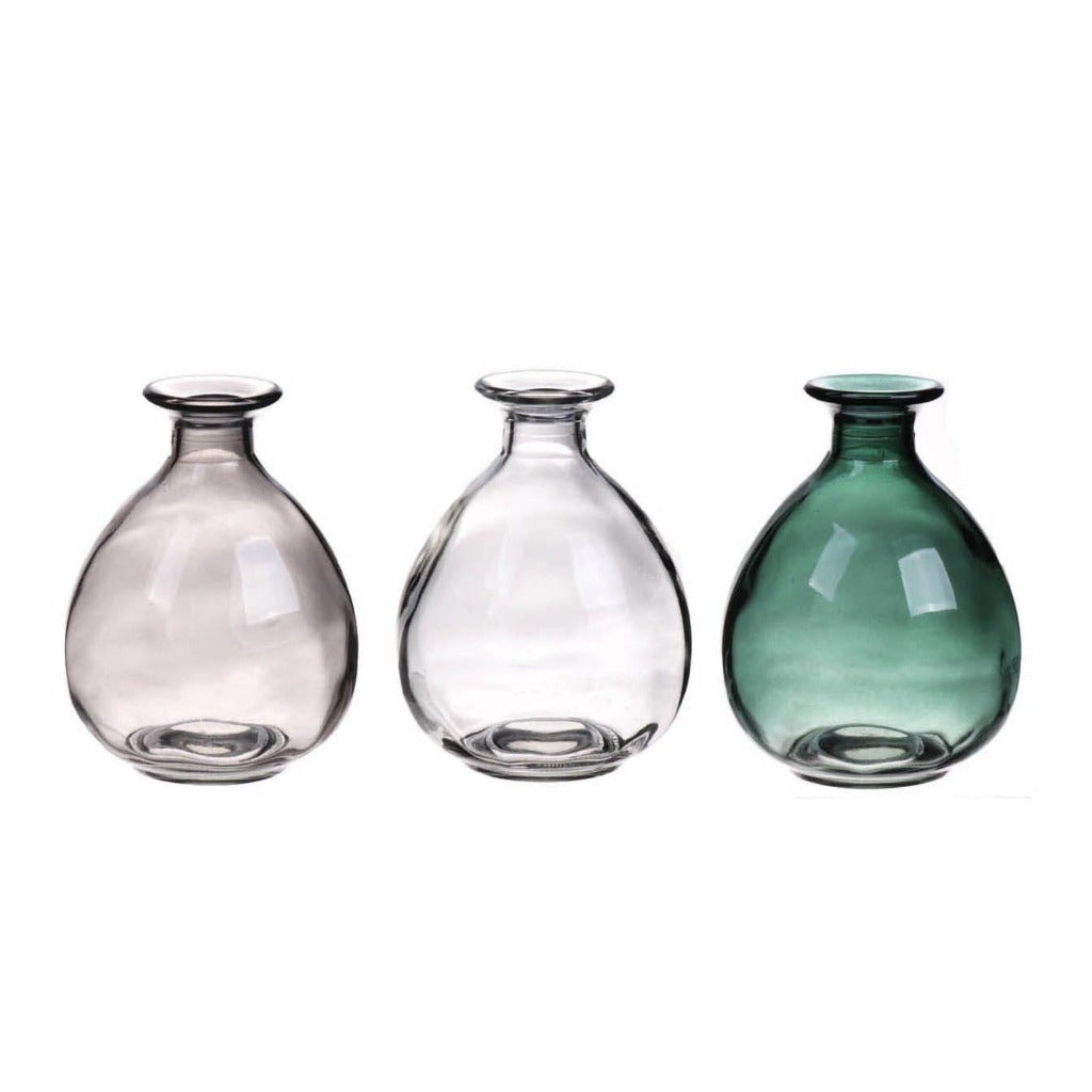 Three round glass vases in gray, clear, and green.