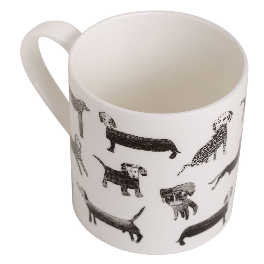 White mug with a pattern of black and white illustrated dogs.