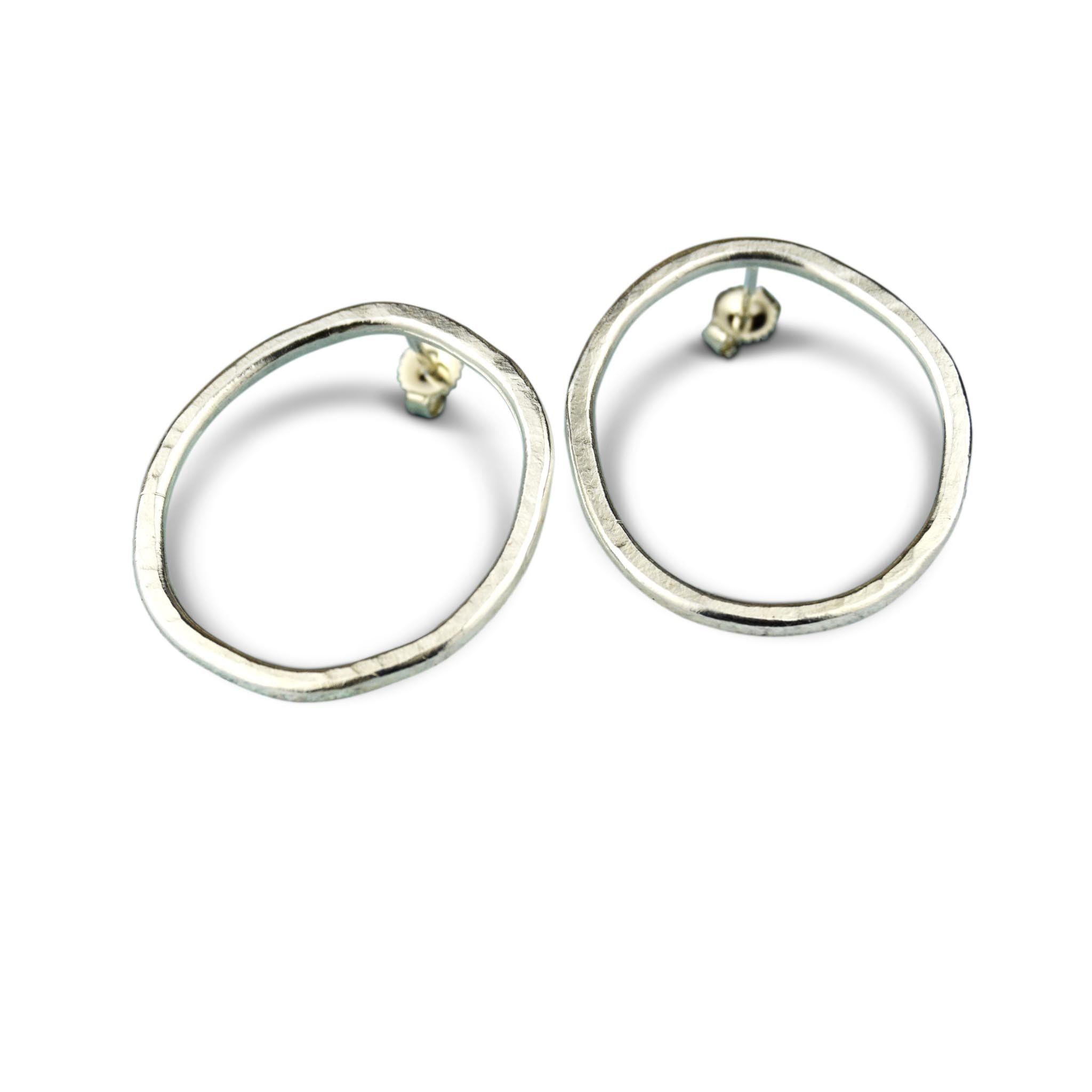 Pair of silver oval-shaped stud earrings with a hammered texture.