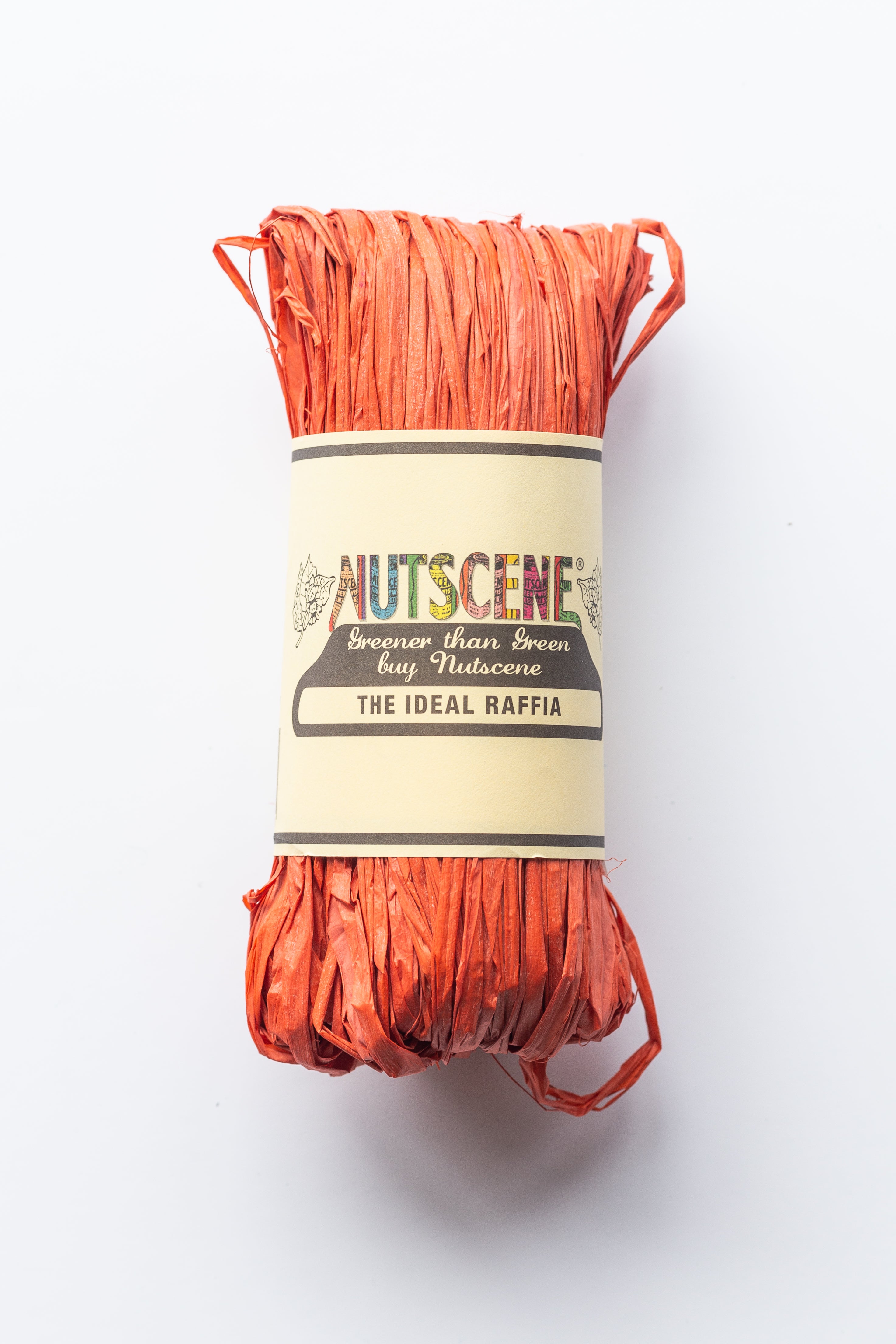 Orange raffia roll labeled "Nutsceene The Ideal Raffia."  Greener than Green.
