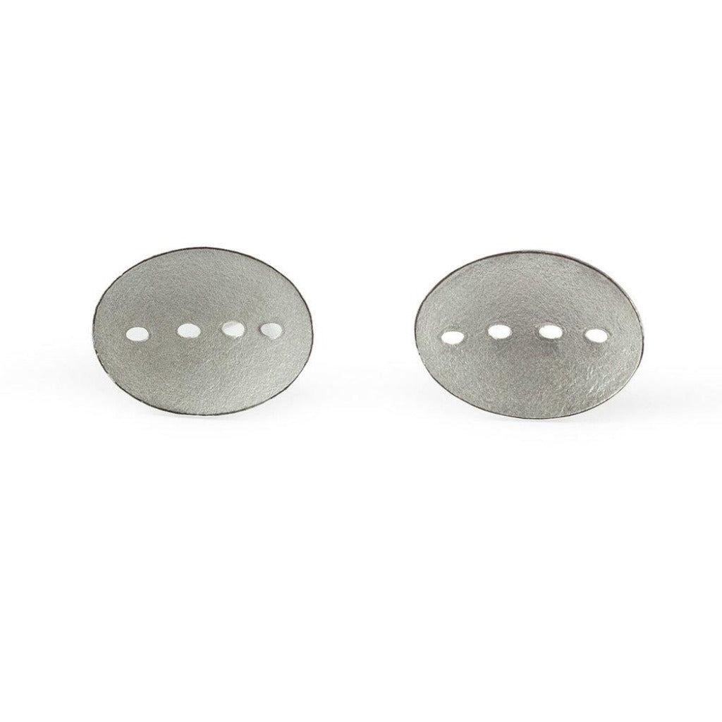 Pair of oval silver earrings; each features four small, evenly spaced cutouts.