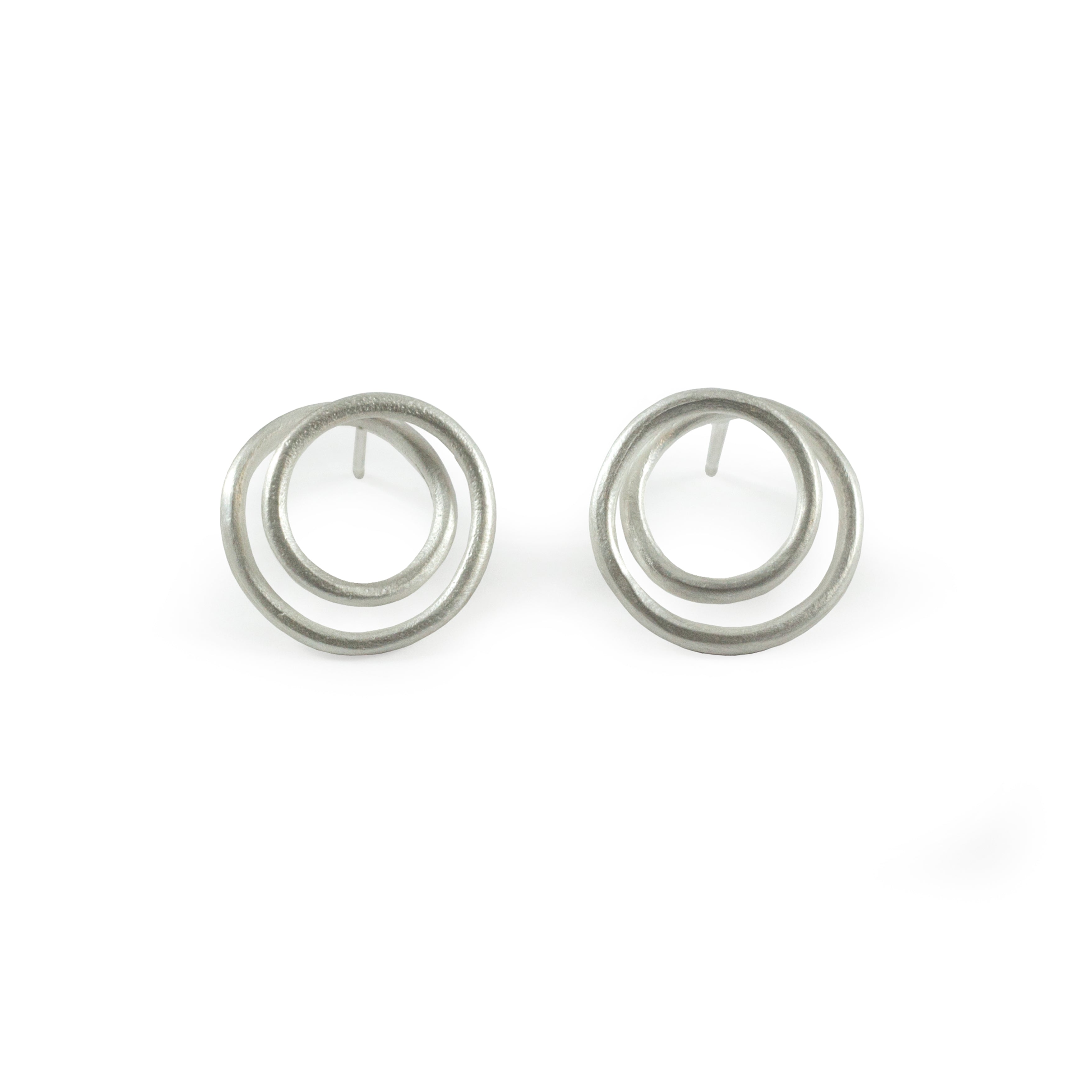 Pair of silver, double-circle stud earrings.  The circles are slightly textured and overlap.