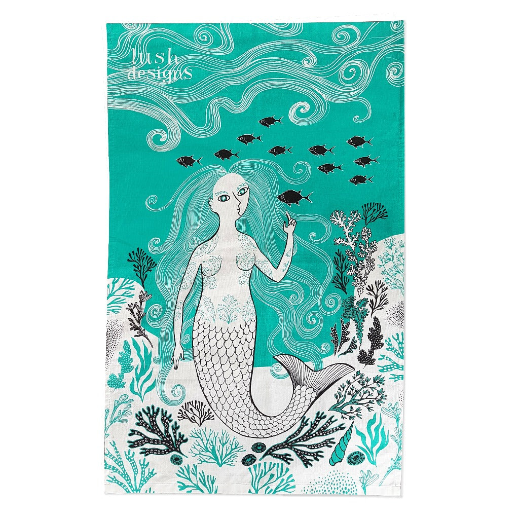 Teal tea towel featuring a stylized mermaid with long flowing hair, surrounded by seaweed and fish.