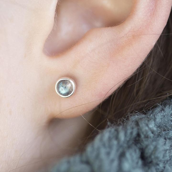 Silver stud earrings featuring round labradorite gemstones.