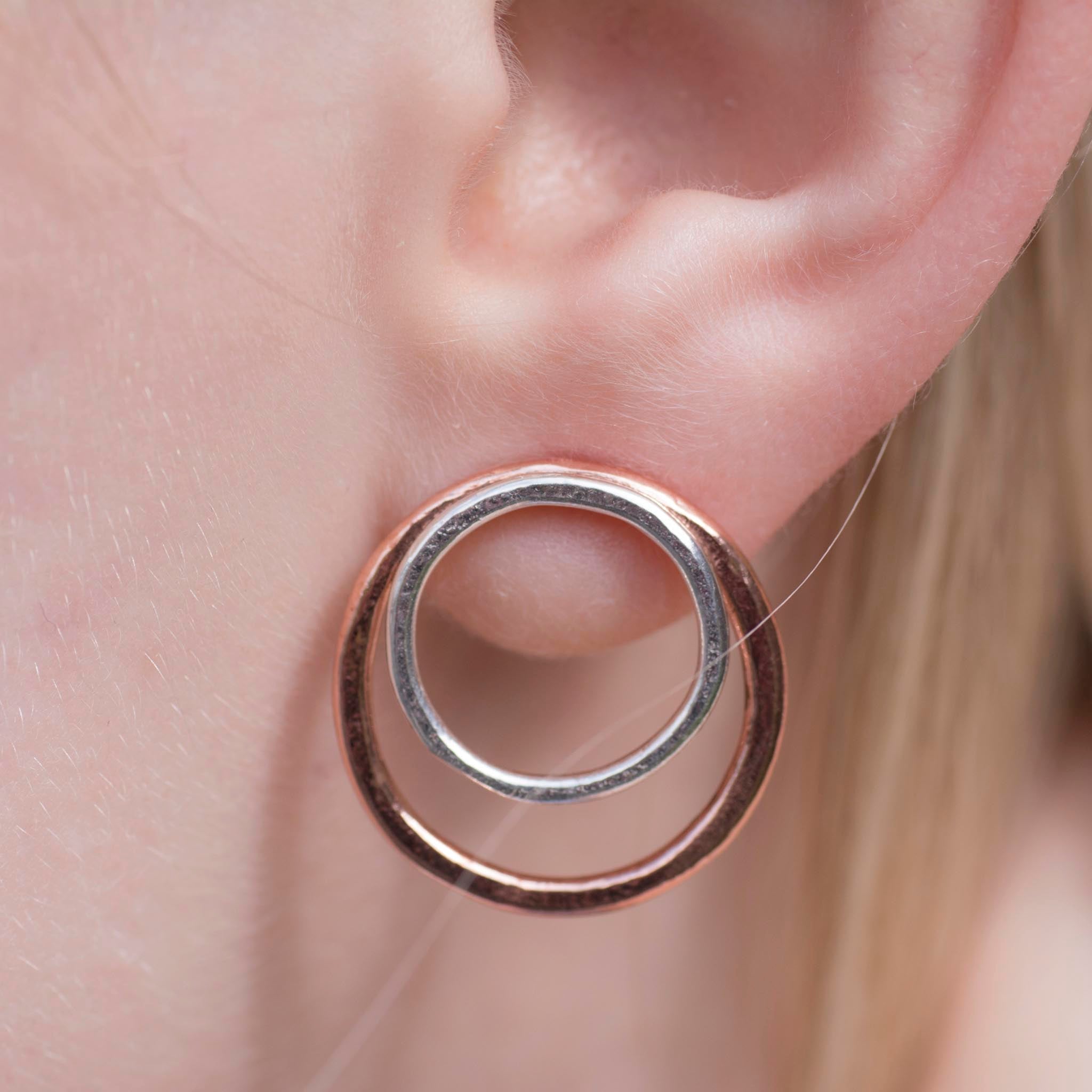 Rose gold and silver double circle stud earrings.